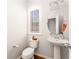 A stylish powder room featuring an oval mirror, modern lighting, and pedestal sink, offering convenience for guests at 24 Rockland Pl, Decatur, GA 30030