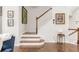 A well-lit staircase with hardwood steps, white railing, and art adds a touch of elegance to the space at 24 Rockland Pl, Decatur, GA 30030