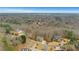 This aerial view features a home nestled among mature trees, in a neighborhood surrounded by forest at 325 William Falls Dr, Canton, GA 30114