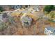 An aerial view shows the layout of this hillside lot with mature trees, and a private back deck at 325 William Falls Dr, Canton, GA 30114