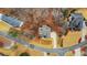 An aerial shot of a home with a long driveway on a large lot, surrounded by mature trees at 325 William Falls Dr, Canton, GA 30114