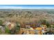 An aerial view of a neighborhood and its surroundings; this home is nestled among mature trees at 325 William Falls Dr, Canton, GA 30114