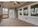 Screened-in back porch showcasing wood flooring, white railing, and an abundance of natural light at 325 William Falls Dr, Canton, GA 30114