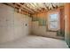 Unfinished basement showing concrete walls, ceiling joists and a window providing natural light at 325 William Falls Dr, Canton, GA 30114