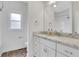 Bathroom featuring white cabinetry, a large mirror and granite countertops at 325 William Falls Dr, Canton, GA 30114
