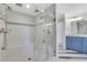 Modern shower with a glass door, dual shower heads, and decorative tile accents at 325 William Falls Dr, Canton, GA 30114