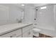 Bright bathroom features granite countertop, white cabinets, framed mirror, and shower-tub combination at 325 William Falls Dr, Canton, GA 30114