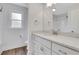 Bathroom featuring white cabinetry, a large mirror, granite countertops, and natural light at 325 William Falls Dr, Canton, GA 30114