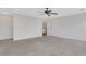 Large bedroom features neutral carpet, ceiling fan, and view of the staircase and hardwood floors at 325 William Falls Dr, Canton, GA 30114