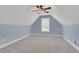 Light blue bedroom featuring neutral carpet, a ceiling fan, and a window with blinds at 325 William Falls Dr, Canton, GA 30114