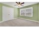 Bright green bedroom featuring soft carpet, a ceiling fan, a window and a closet at 325 William Falls Dr, Canton, GA 30114