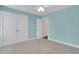 A calming light blue bedroom with carpet, a ceiling fan, and a closet at 325 William Falls Dr, Canton, GA 30114