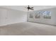 Spacious light-filled bedroom with neutral carpet and a three panel window showcasing an outdoor view at 325 William Falls Dr, Canton, GA 30114