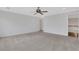 Large bonus room with neutral carpet, ceiling fan, and view of the staircase and hardwood floors at 325 William Falls Dr, Canton, GA 30114