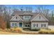 Charming two-story home with stone accents and a welcoming blue front door at 325 William Falls Dr, Canton, GA 30114