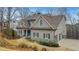 Beautiful two-story home featuring stone accents, gray siding, and a three-car garage in a lovely neighborhood at 325 William Falls Dr, Canton, GA 30114