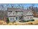 Charming home with a welcoming porch, gray siding, stone accents, and well-maintained landscaping at 325 William Falls Dr, Canton, GA 30114