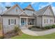 Inviting two-story home with manicured lawn and stone accents on a sunny day at 325 William Falls Dr, Canton, GA 30114