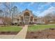Stunning home with a covered porch, manicured lawn, and mature trees, offering superb curb appeal at 325 William Falls Dr, Canton, GA 30114