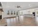 Open living space with a fireplace, hardwood floors, and seamless transition to the modern kitchen at 325 William Falls Dr, Canton, GA 30114