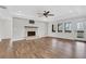 Bright living room with a stone fireplace, hardwood flooring, and access to a private balcony at 325 William Falls Dr, Canton, GA 30114