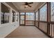 Relaxing screened-in porch with wood flooring, ceiling fan, and wooded view at 325 William Falls Dr, Canton, GA 30114