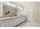 Bright bathroom featuring double sinks with granite countertops and a marble tiled shower at 3538 Davenport Rd, Duluth, GA 30096