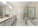 Bright bathroom featuring double sinks with granite countertops and a marble tiled shower at 3538 Davenport Rd, Duluth, GA 30096