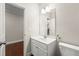 Stylish half-bathroom with a modern vanity, sleek mirror, and neutral color palette next to a small hallway at 3538 Davenport Rd, Duluth, GA 30096