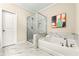 Bathroom featuring a tub and shower combination with marble tile surround and chrome fixtures at 3538 Davenport Rd, Duluth, GA 30096