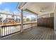 Covered deck with dark wood flooring, a ceiling fan, and views of the neighborhood buildings beyond at 3538 Davenport Rd, Duluth, GA 30096