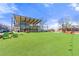 Commercial area with a green, astroturf lawn featuring restaurant and retail storefronts at 3538 Davenport Rd, Duluth, GA 30096