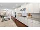 Modern white kitchen with stainless appliances, granite counters, and an open view to the living area at 3538 Davenport Rd, Duluth, GA 30096