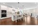 Modern white kitchen with stainless steel appliances, granite countertops, and a spacious island at 3538 Davenport Rd, Duluth, GA 30096
