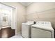 This laundry room features a washer, dryer, and storage shelving for added convenience at 3538 Davenport Rd, Duluth, GA 30096