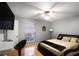 Comfortable bedroom with hardwood floors, a large window, and a stylish bed at 5600 Kingsport Dr, Atlanta, GA 30342