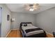 Cozy bedroom featuring hardwood floors, ceiling fan, and a comfortable leather platform bed at 5600 Kingsport Dr, Atlanta, GA 30342