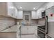 Well-lit kitchen with white cabinets, stainless steel appliances, and granite countertops at 5600 Kingsport Dr, Atlanta, GA 30342