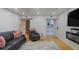 Inviting living room with a black sofa, hardwood floors, and an open doorway to the kitchen at 5600 Kingsport Dr, Atlanta, GA 30342