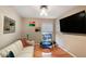 Comfortable living room featuring hardwood floors, a mounted TV, and a mini trampoline at 5600 Kingsport Dr, Atlanta, GA 30342