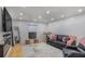 Bright living room featuring recessed lighting, hardwood floors, and a stylish gray sofa with pink accents at 5600 Kingsport Dr, Atlanta, GA 30342