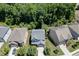 Aerial shot featuring beautiful home, landscaped yard, and lush green trees at 607 Leland Pkwy, Cumming, GA 30041