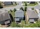 Aerial view featuring home with landscaped yard, deck, and lush green trees at 607 Leland Pkwy, Cumming, GA 30041