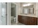 Bathroom featuring a vanity with dark wood cabinets, undermount sink, and a combined tub and shower at 607 Leland Pkwy, Cumming, GA 30041