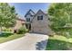 Beautifully landscaped home with a well-maintained lawn, features a stone facade and a driveway leading to a two-car garage at 607 Leland Pkwy, Cumming, GA 30041