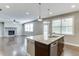 Open floor plan showcasing a stone fireplace and granite island with pendant lights at 607 Leland Pkwy, Cumming, GA 30041