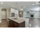Open-concept home featuring a modern kitchen, stone fireplace and an adjacent living area at 607 Leland Pkwy, Cumming, GA 30041
