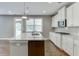 Bright kitchen featuring stainless appliances, granite counters, and hardwood floors at 607 Leland Pkwy, Cumming, GA 30041
