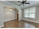 Bright living room with hardwood floors, arched doorway, and a ceiling fan at 607 Leland Pkwy, Cumming, GA 30041