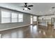 Open living room with hardwood floors, a kitchen, and plenty of natural light at 607 Leland Pkwy, Cumming, GA 30041